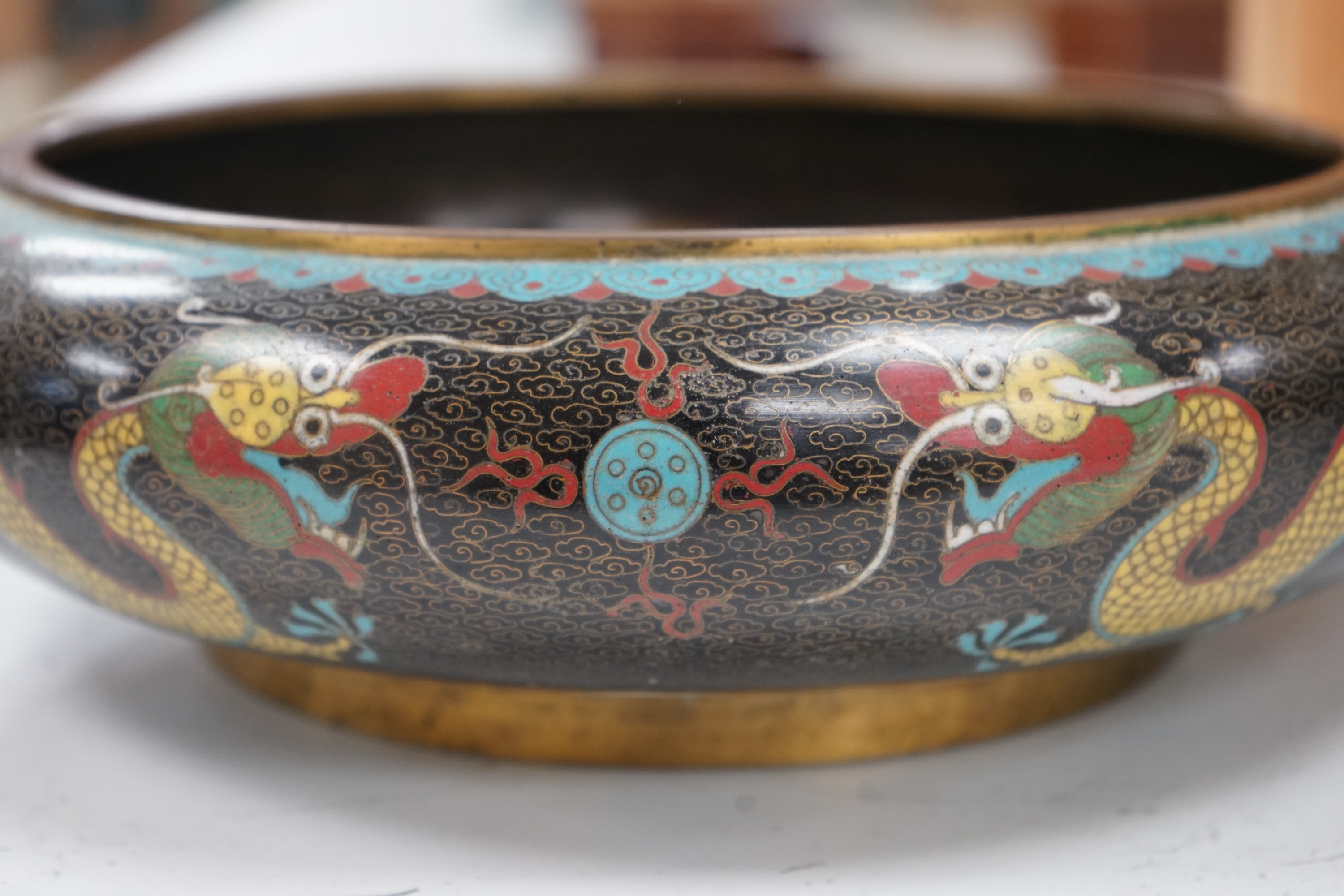 A pair of early 20th century Chinese cloisonné enamel ‘dragon’ bowls, 30cm diameter. Condition - fair to good